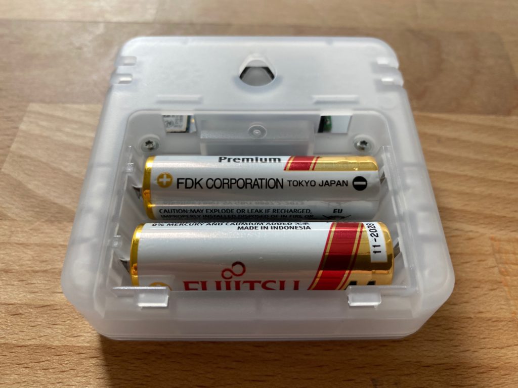 Two AA batteries powering the Aranet4 CO2, temperature and humidity sensor